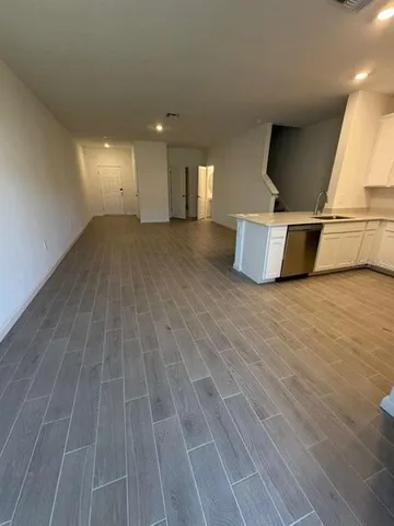 a view of a room with wooden floor