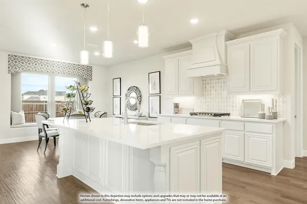 a kitchen with counter top space a sink appliances and cabinets