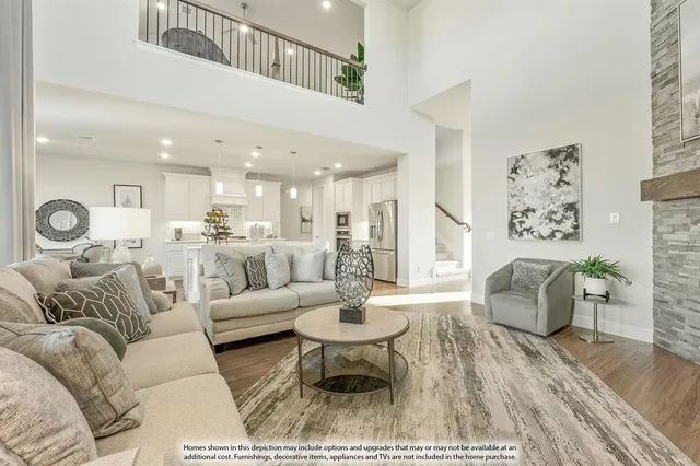 a living room with furniture and view of kitchen