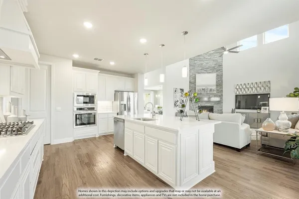 a large white living room with stainless steel appliances kitchen island lots of white furniture a chandelier wooden floor and a large window
