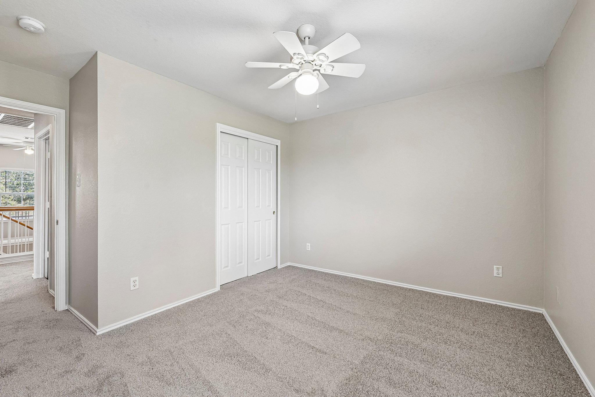 616 Scheel Road Kyle, TX 78640 - Photo 28 of 39 Comfortable bedroom with plush carpeting and essential cooling with a ceiling fan.