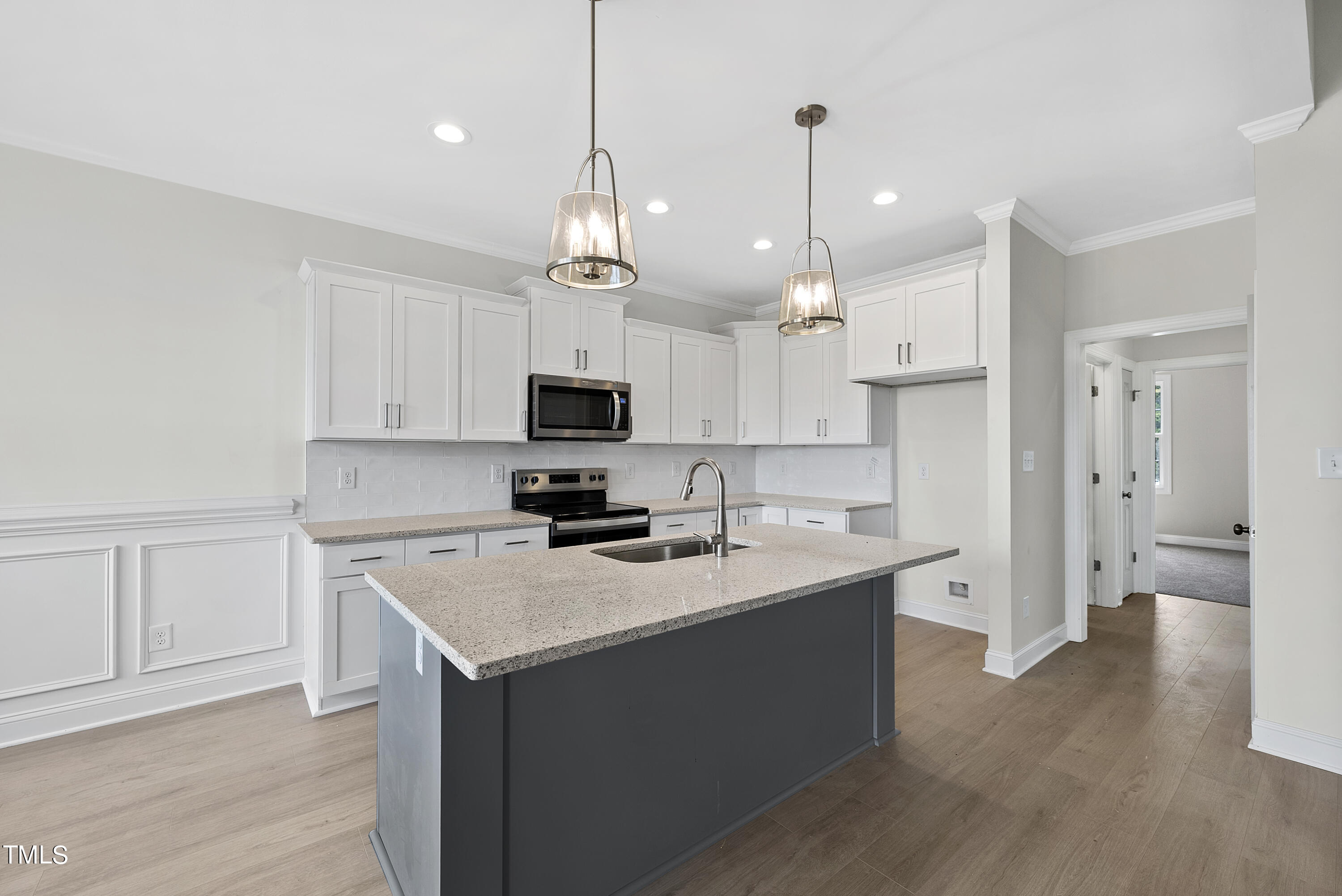 5336 River Buck Rd Spring Spring Hope, NC 27882 - Photo 8 of 39 a kitchen with kitchen island a white counter top space stainless steel appliances and cabinets