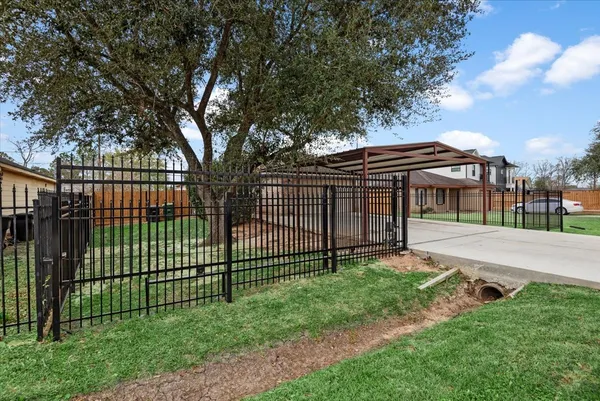 a view of a backyard with a garden and entertaining space