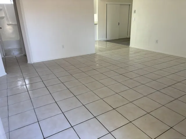 a view of an empty room and wooden floor