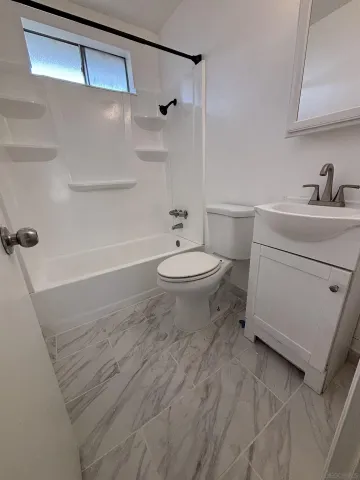a view of a dining room with furniture and a kitchen