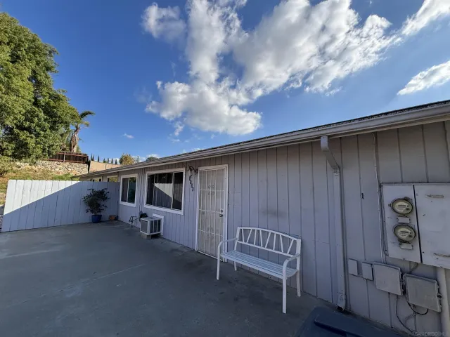 a backyard of a house with table and chairs