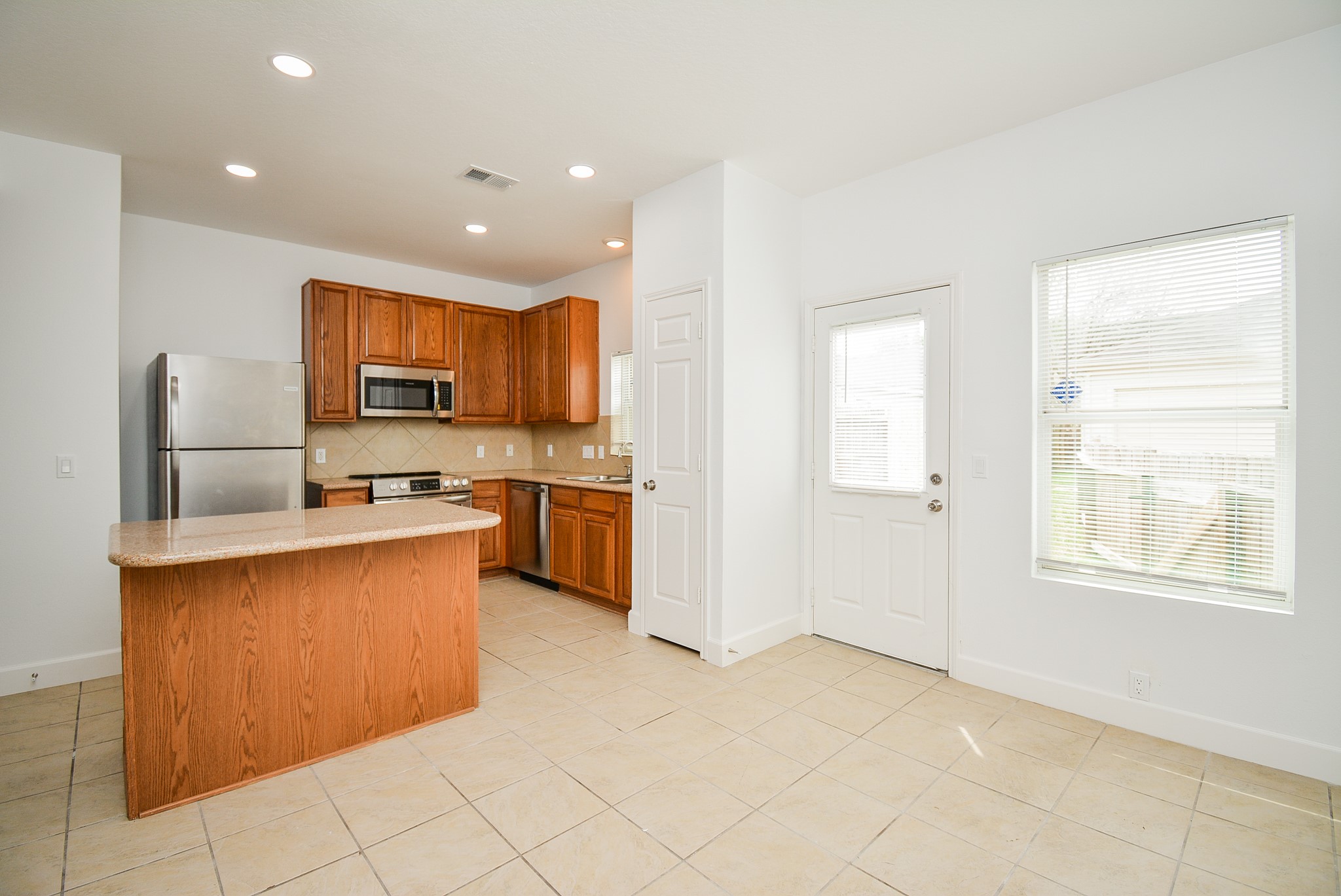 29725 Sullivan Oaks Drive Spring, TX 77386 - Photo 12 of 32 a kitchen with stainless steel appliances a refrigerator and a stove top oven