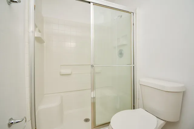 a white toilet sitting next to a bathroom sink