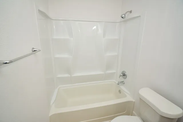 a bathroom with a bathtub and a toilet