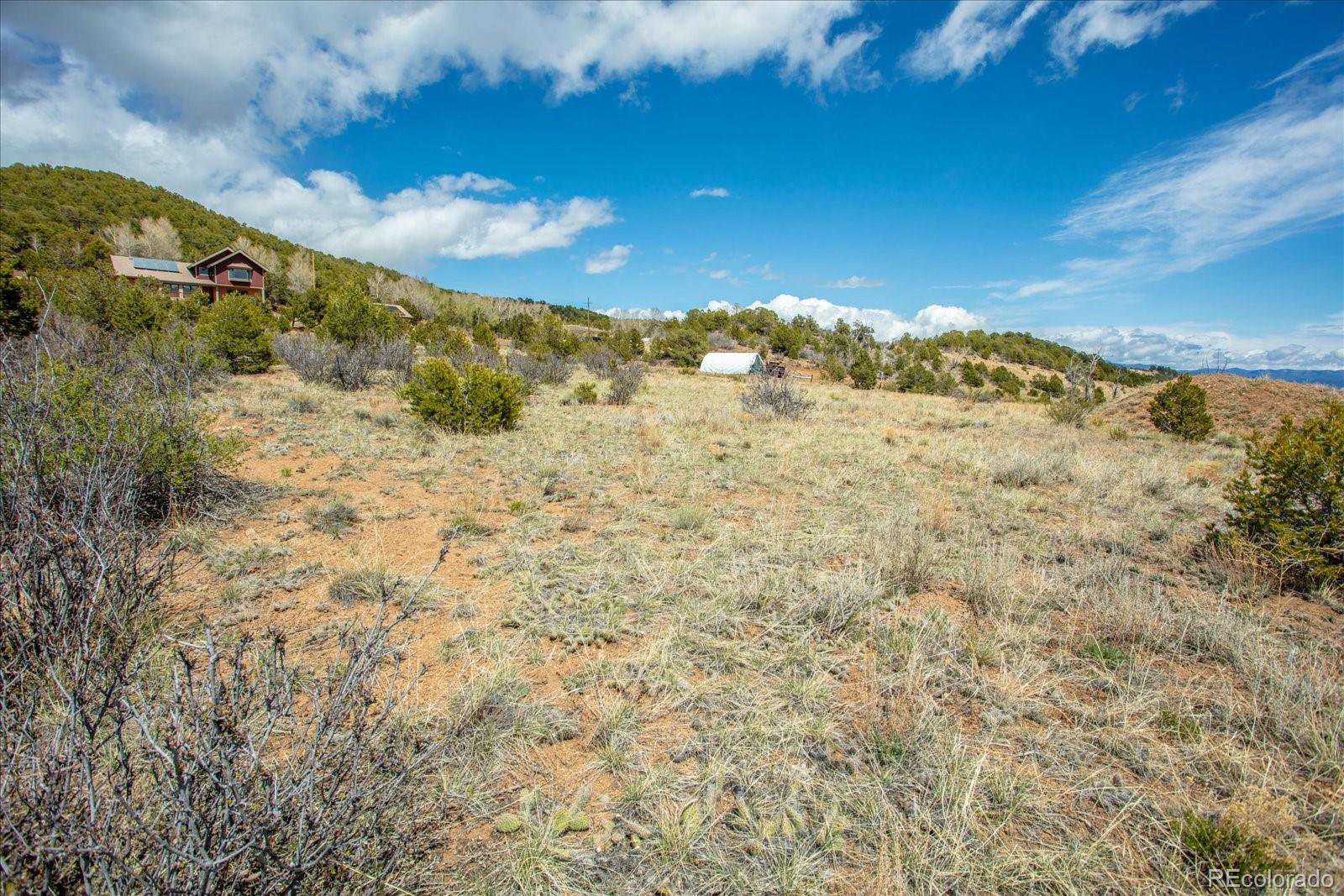 8209 Rocky Mountain Road Salida, CO 81201 - Photo 26 of 27 a view of a dry yard with mountains in the background