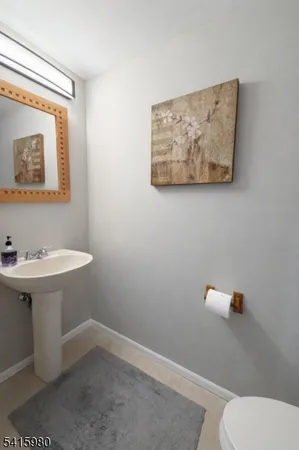 a bathroom with a sink mirror and toilet