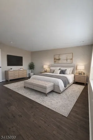 a bedroom with a large bed and a flat screen tv