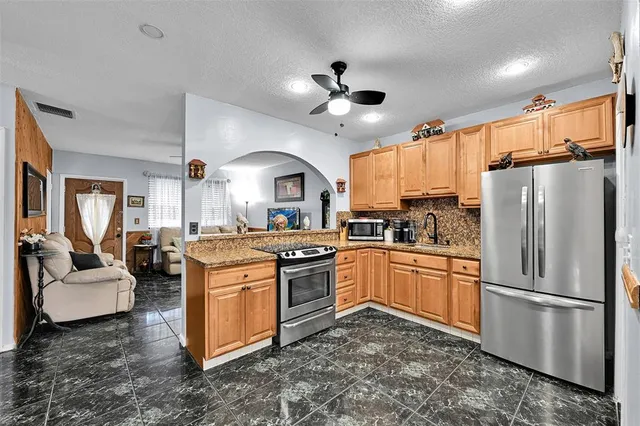 a kitchen with a sink stainless steel appliances and cabinets