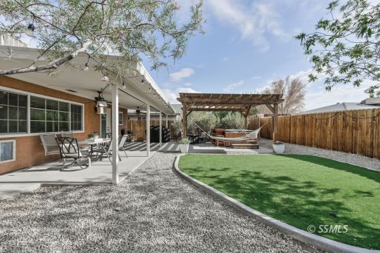 1267 North Erwin Street Ridgecrest, CA 93555 - Photo 34 of 35 a view of a chair and table in backyard of the house