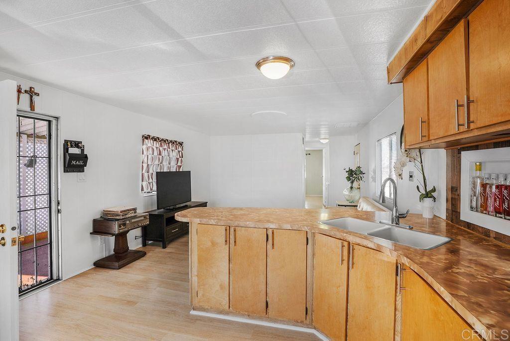 998 East Main Street, Unit 50 El Cajon, CA 92021 - Photo 4 of 18 a living room with stainless steel appliances kitchen island granite countertop a sink and cabinets