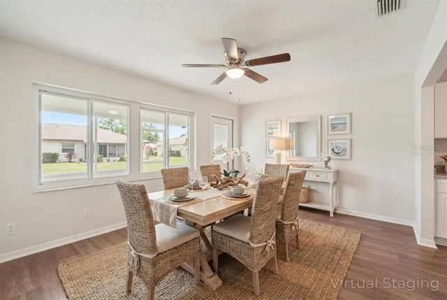 an empty room with wooden floor and ceiling fan