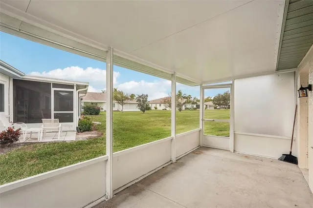 an aerial view of a residential houses with outdoor space and trees