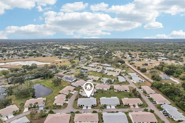 an aerial view of a residential houses with outdoor space