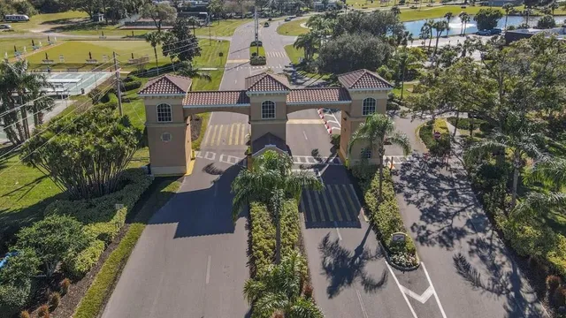 an aerial view of a residential houses with outdoor space and a lake view