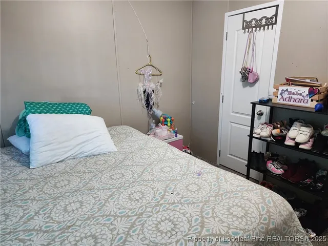 a bedroom with a bed and a wall painting