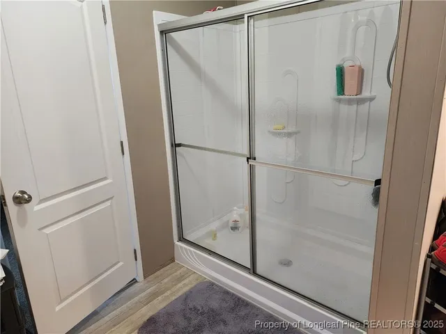 a bathroom with a glass shower door