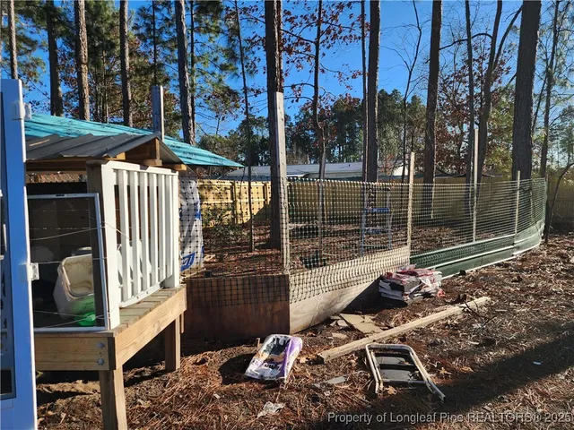 a backyard of a house with barbeque oven and outdoor seating