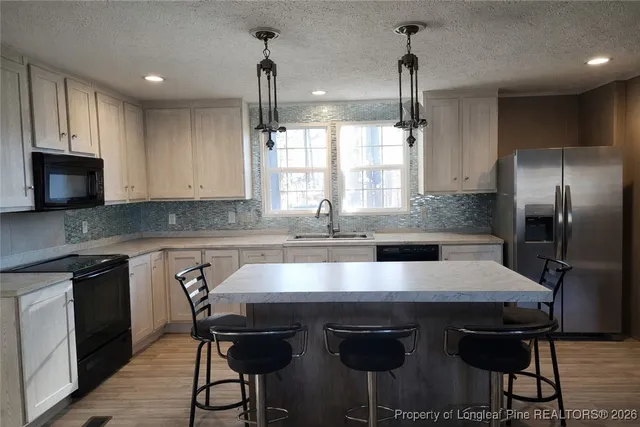 a kitchen with a stove a sink and a refrigerator