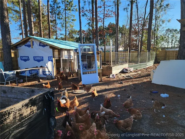a view of a patio with lawn chairs and wooden floor
