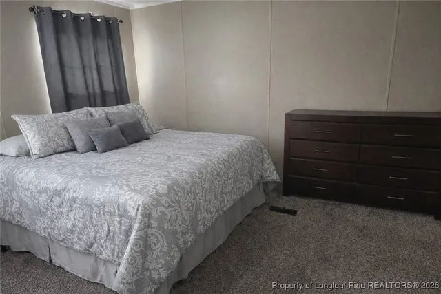 a bedroom with a bed and a mirror