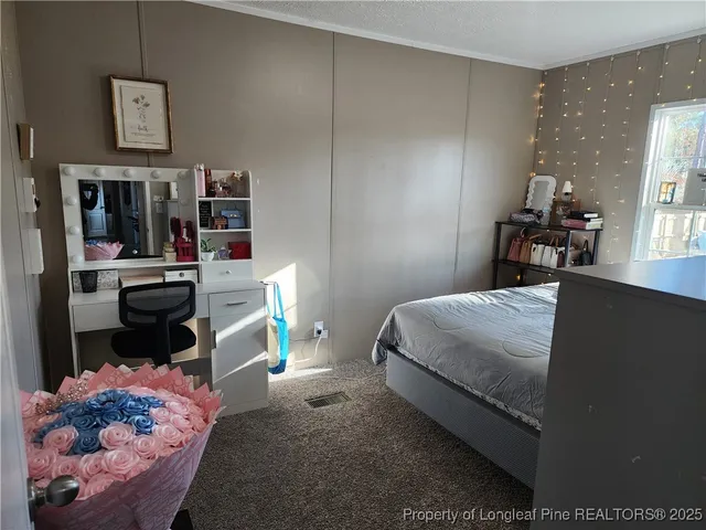 a bedroom with a bed and a couch