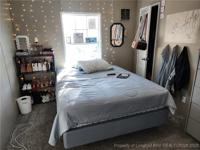 a bedroom with a bed and dresser with mirror