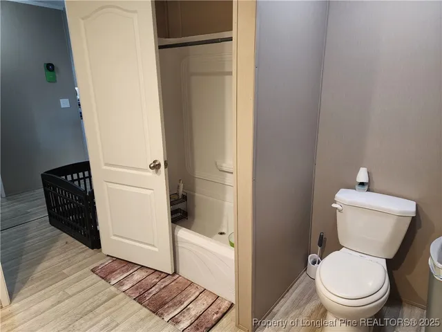 a white toilet sitting next to a bathroom sink