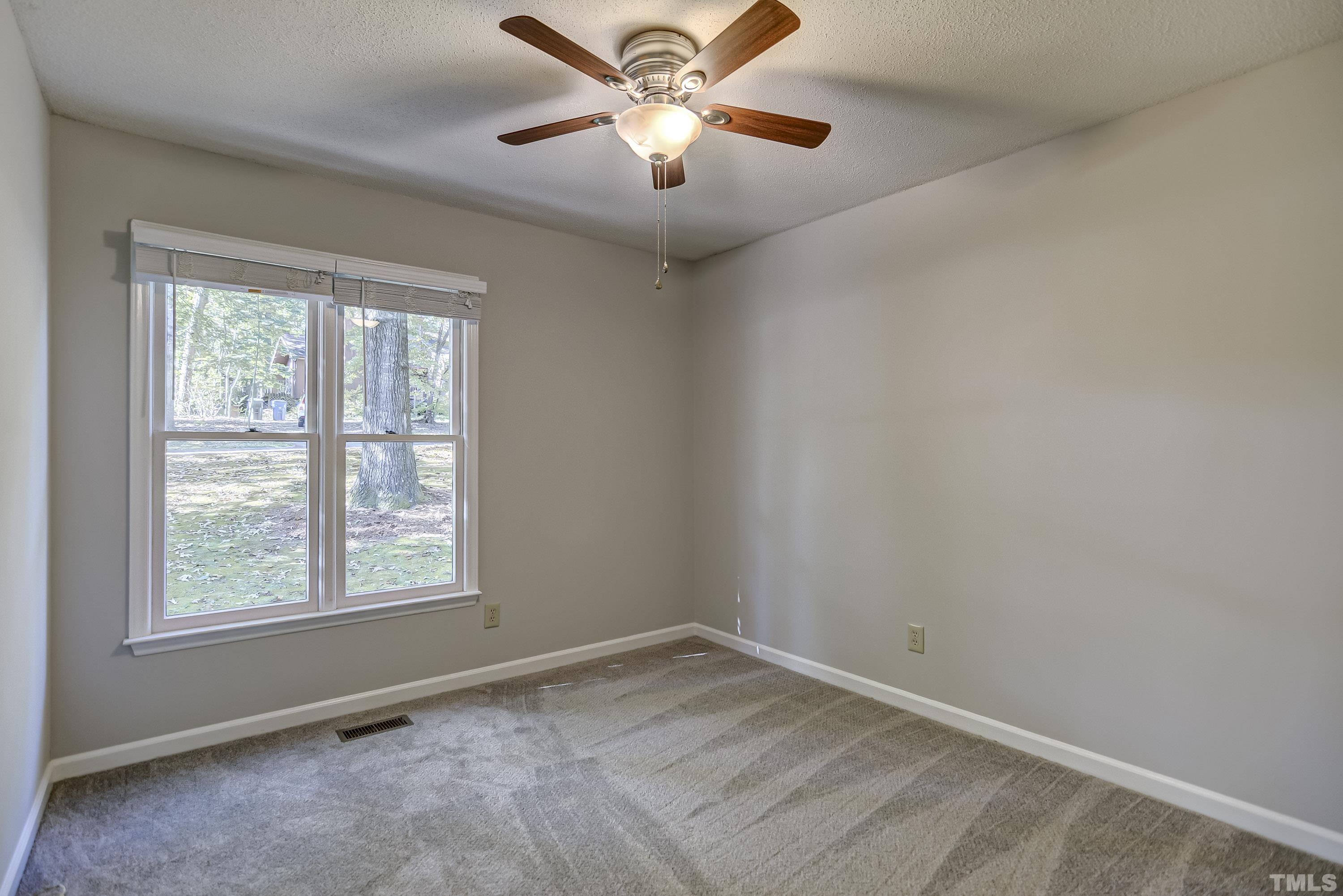 7400 Old Hundred Road Raleigh, NC 27613 - Photo 11 of 17 an empty room with a window and a fan