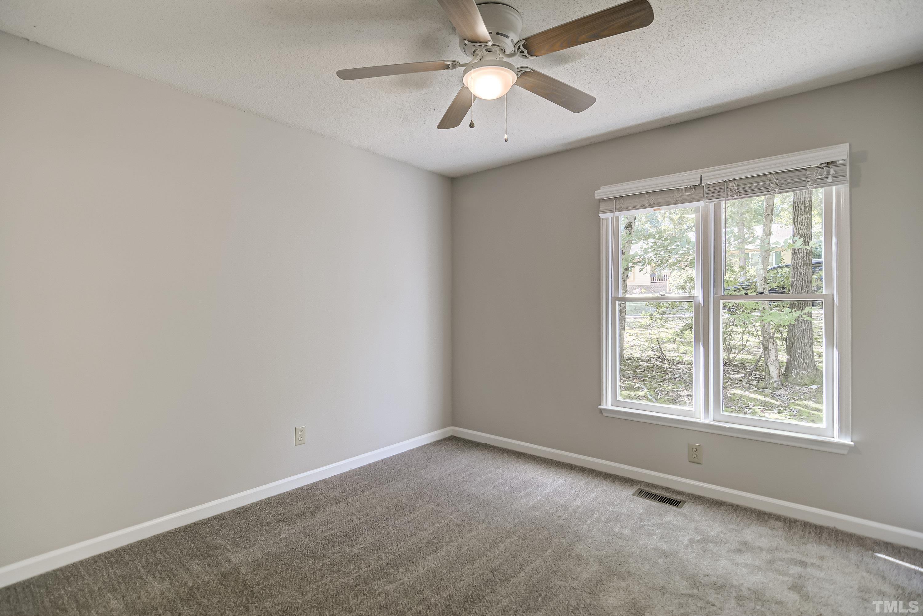 7400 Old Hundred Road Raleigh, NC 27613 - Photo 12 of 17 an empty room with a window and a fan