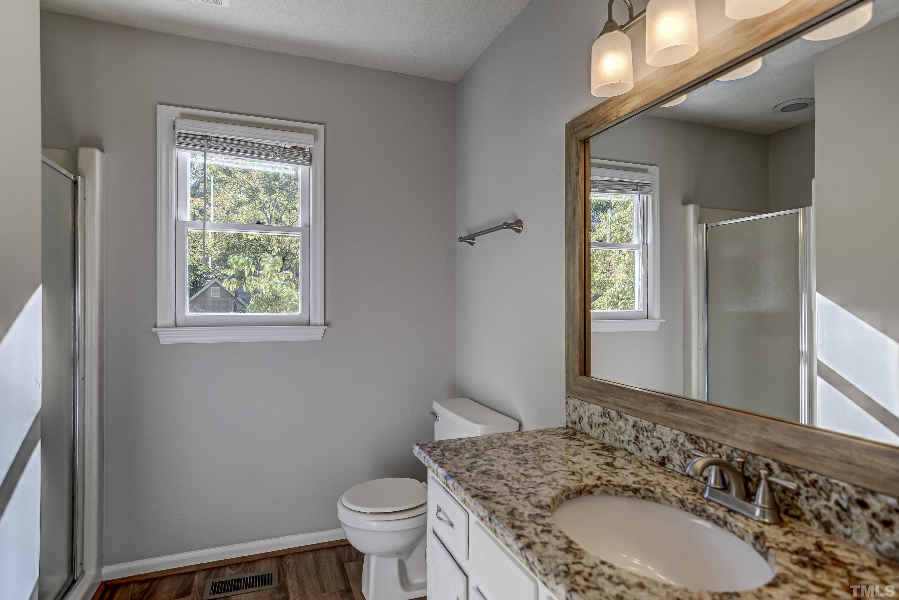 7400 Old Hundred Road Raleigh, NC 27613 - Photo 8 of 17 a bathroom with a sink toilet and window