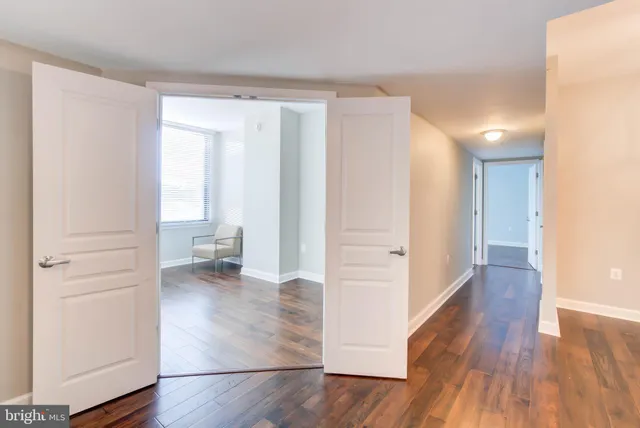 a view of a room with wooden floor