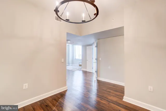 a view of a room with wooden floor and white walls