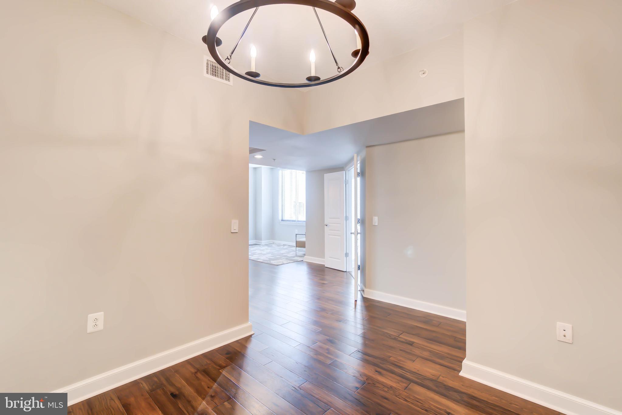 2451 Midtown Avenue, Unit 1327 Alexandria, VA 22303 - Photo 13 of 32 a view of a room with wooden floor and white walls