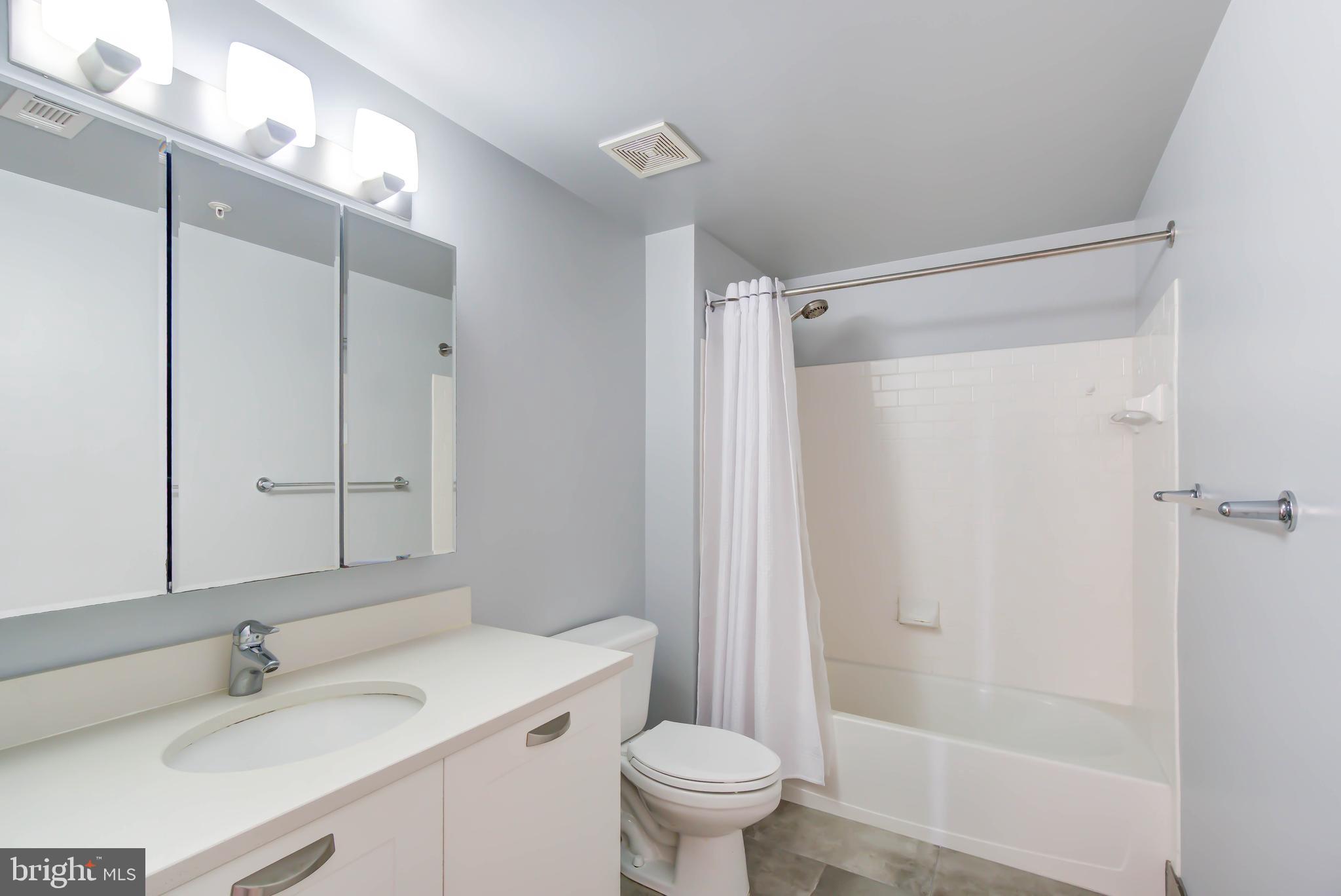 2451 Midtown Avenue, Unit 1327 Alexandria, VA 22303 - Photo 22 of 32 a bathroom with a sink toilet and shower