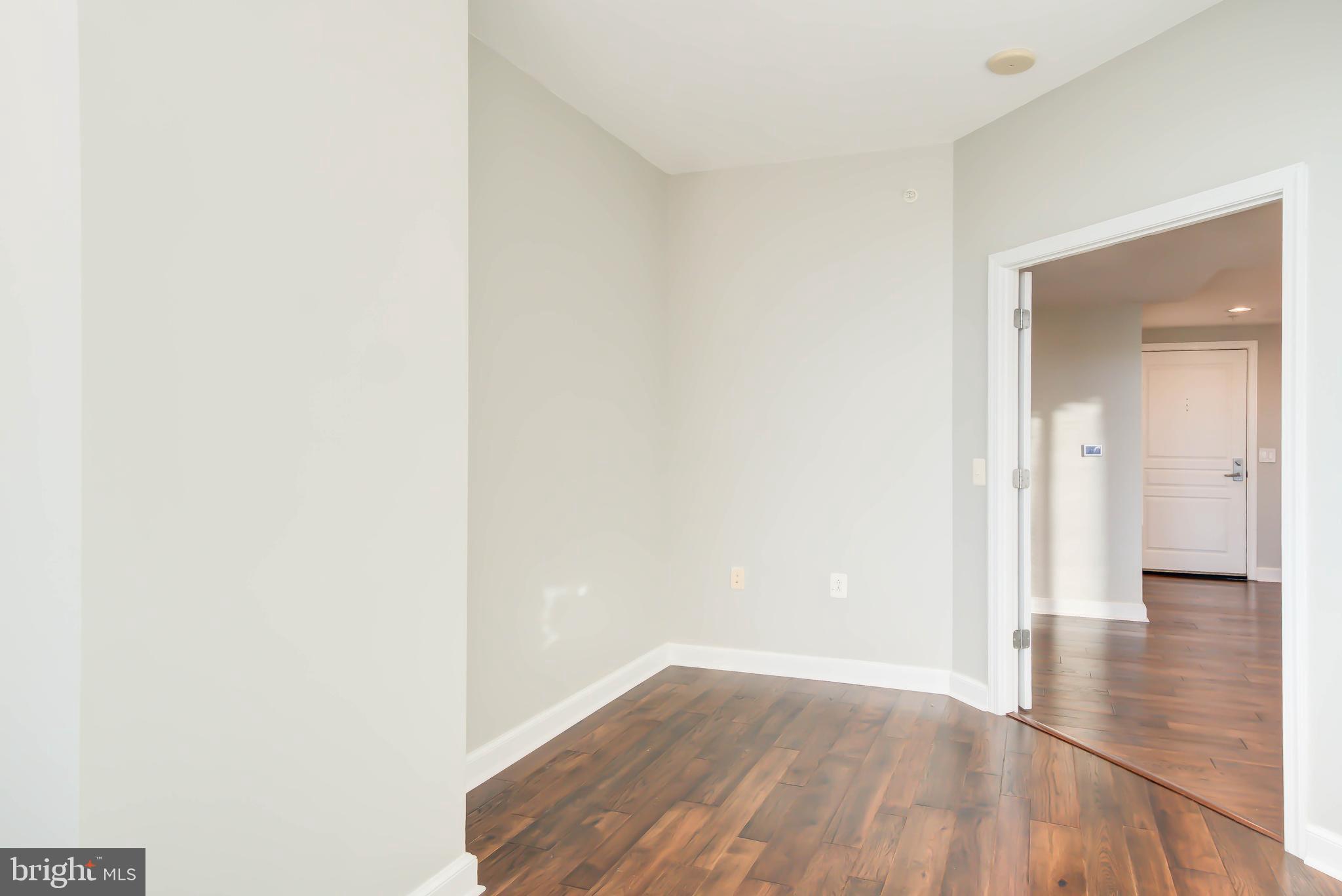 2451 Midtown Avenue, Unit 1327 Alexandria, VA 22303 - Photo 25 of 32 a view of a hallway with wooden floor