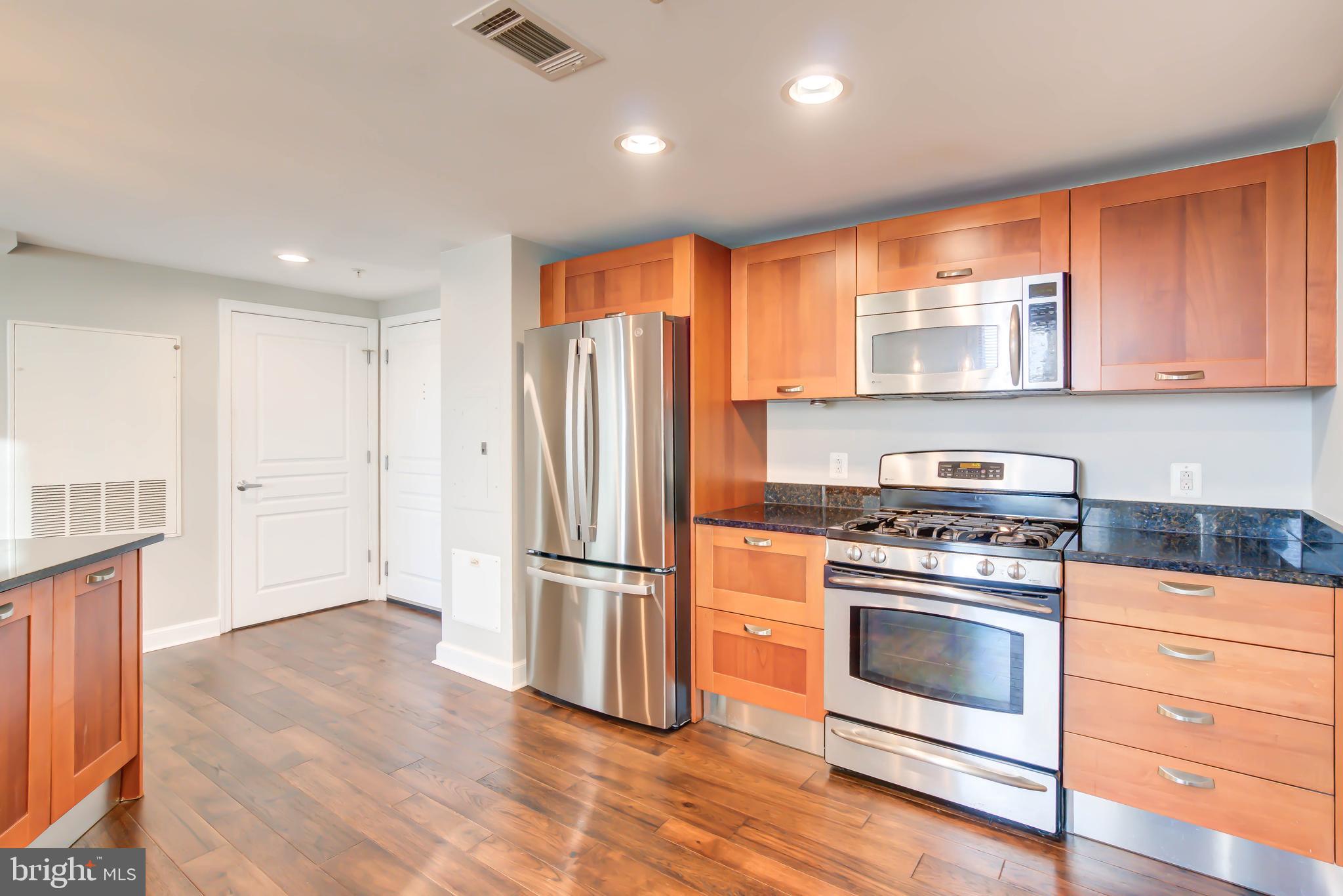 2451 Midtown Avenue, Unit 1327 Alexandria, VA 22303 - Photo 5 of 32 a kitchen with a stove a refrigerator and a window