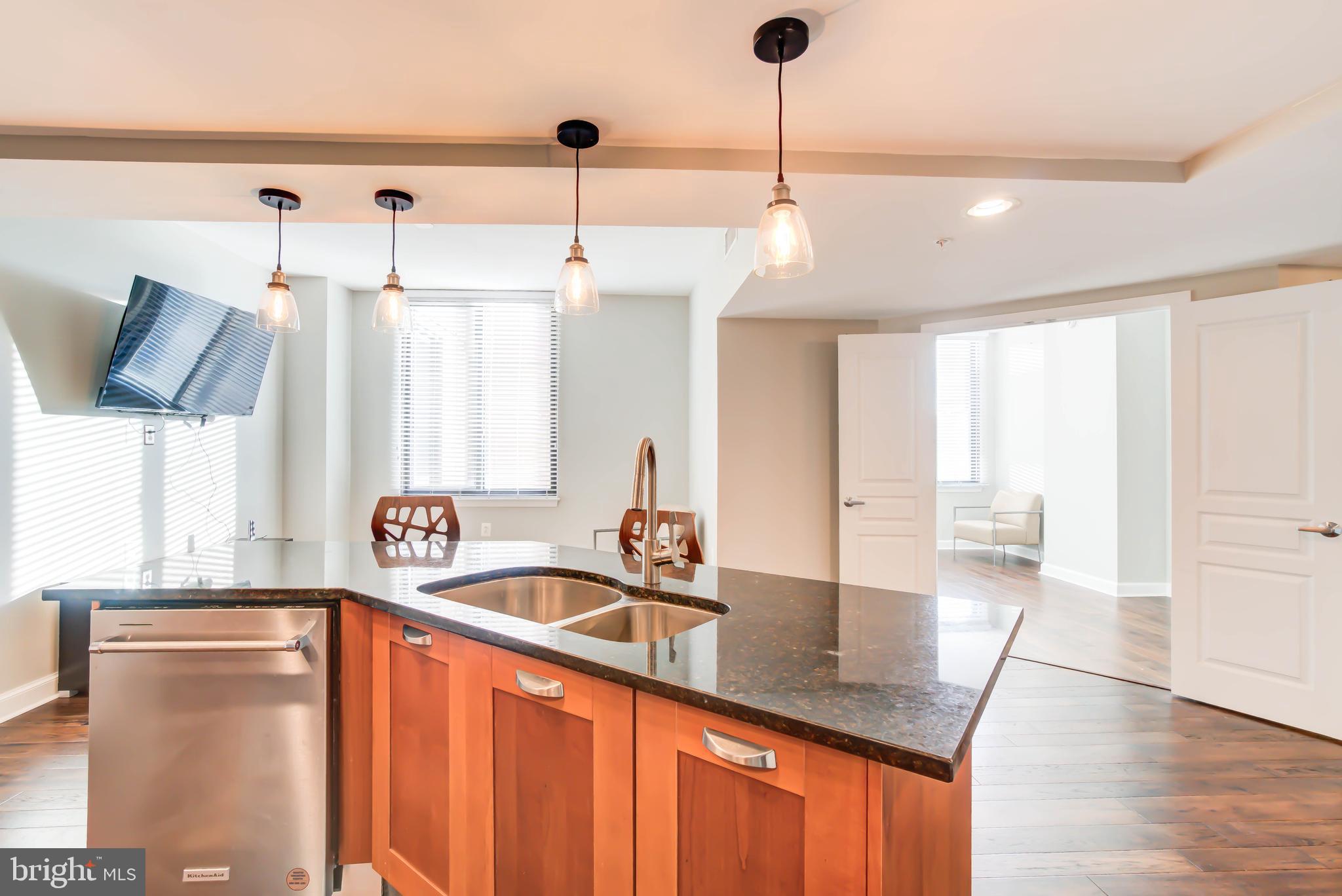 2451 Midtown Avenue, Unit 1327 Alexandria, VA 22303 - Photo 7 of 32 a kitchen with stainless steel appliances granite countertop a sink a window and wooden floor