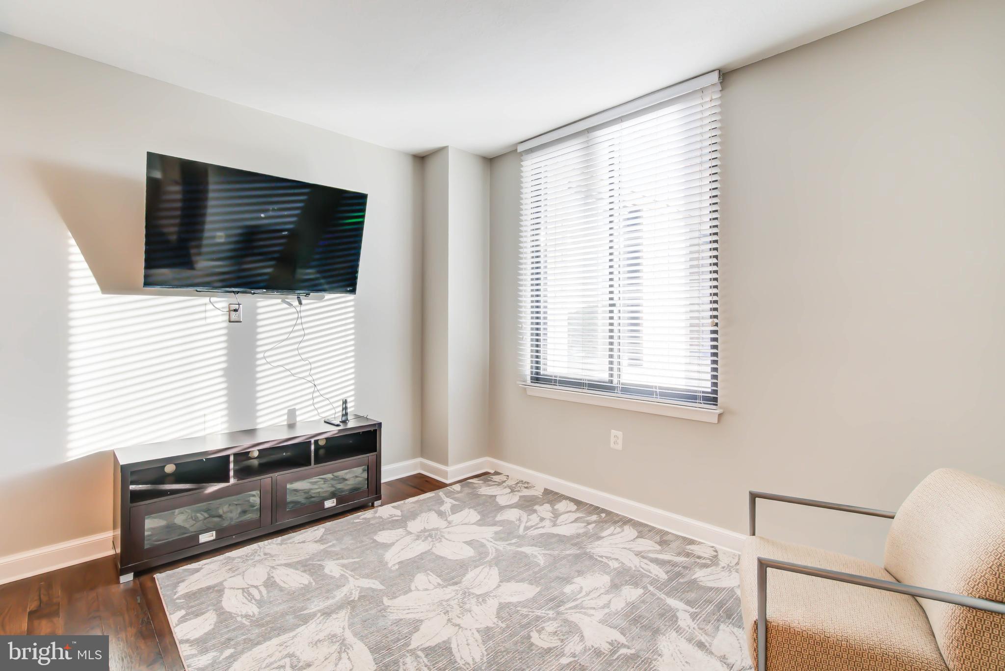 2451 Midtown Avenue, Unit 1327 Alexandria, VA 22303 - Photo 8 of 32 a large bedroom with a bed and flat screen tv