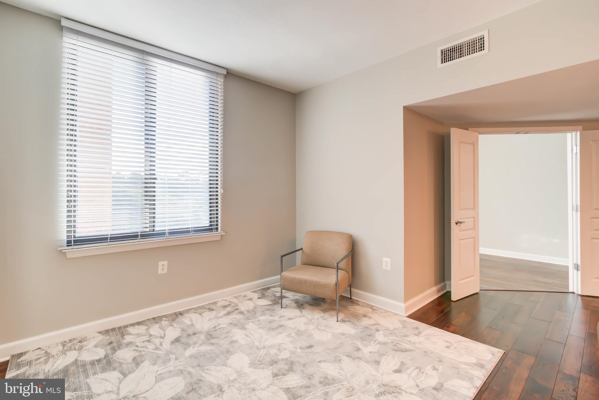 2451 Midtown Avenue, Unit 1327 Alexandria, VA 22303 - Photo 9 of 32 a view of a livingroom with wooden floor and a window