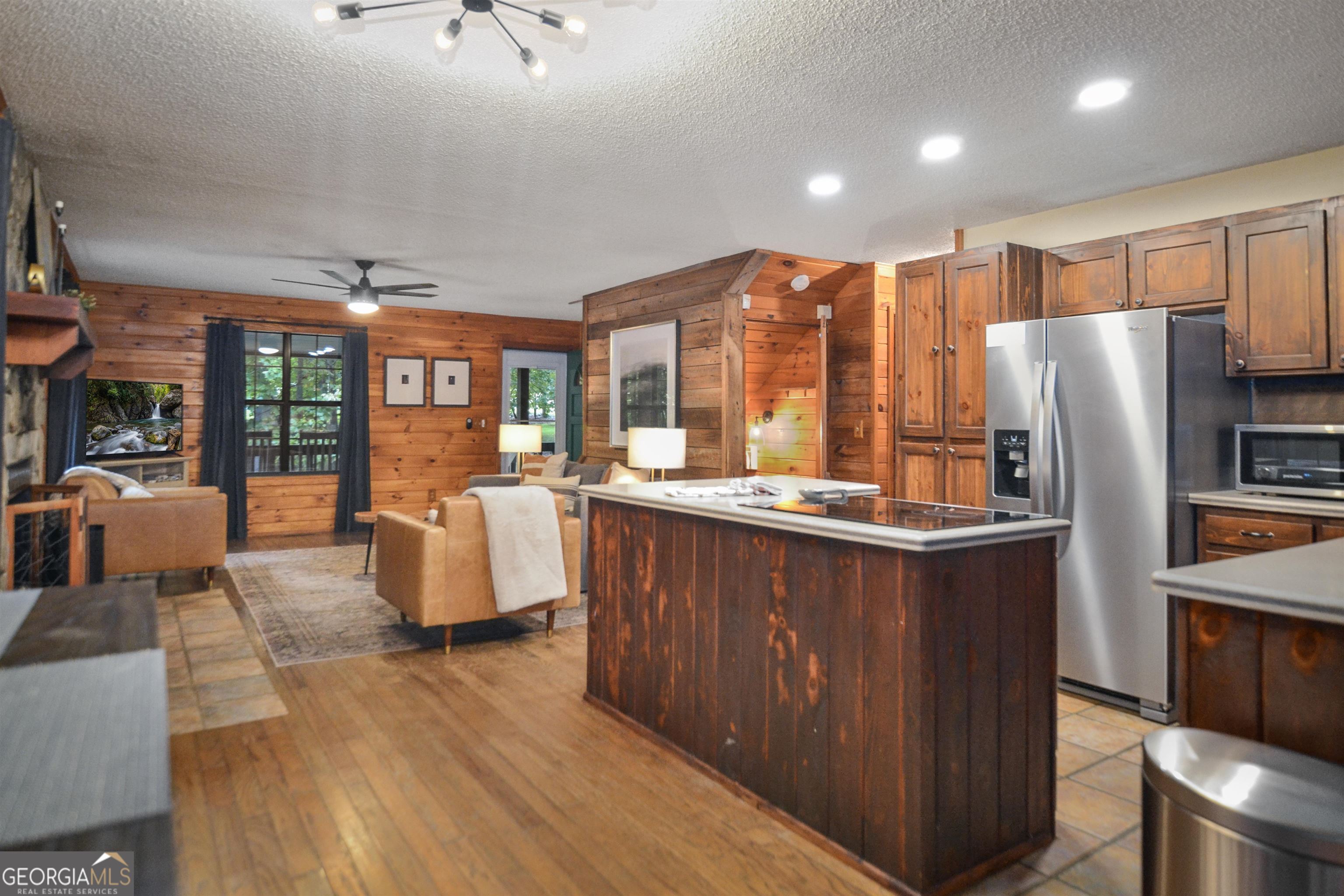 161 Old Dial Road Morganton, GA 30560 - Photo 18 of 40 a kitchen with stainless steel appliances granite countertop a refrigerator a stove and a sink with wooden floors
