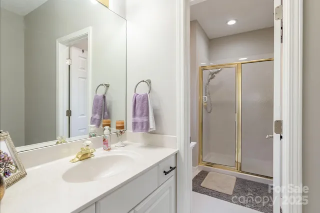 a bathroom with a double vanity sink mirror and shower