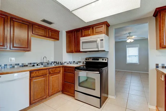 a kitchen with stainless steel appliances granite countertop a stove sink and microwave