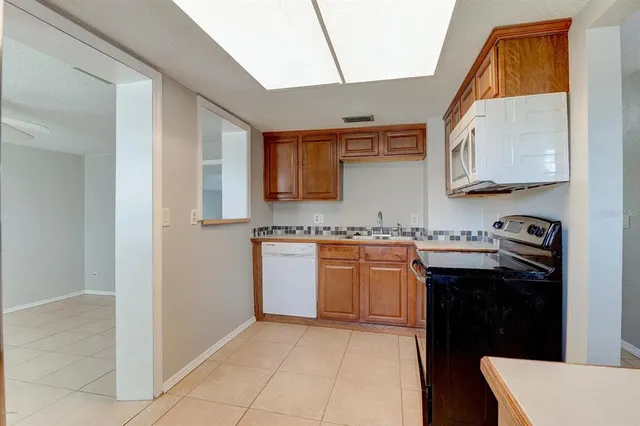 a kitchen with granite countertop a sink and a stove