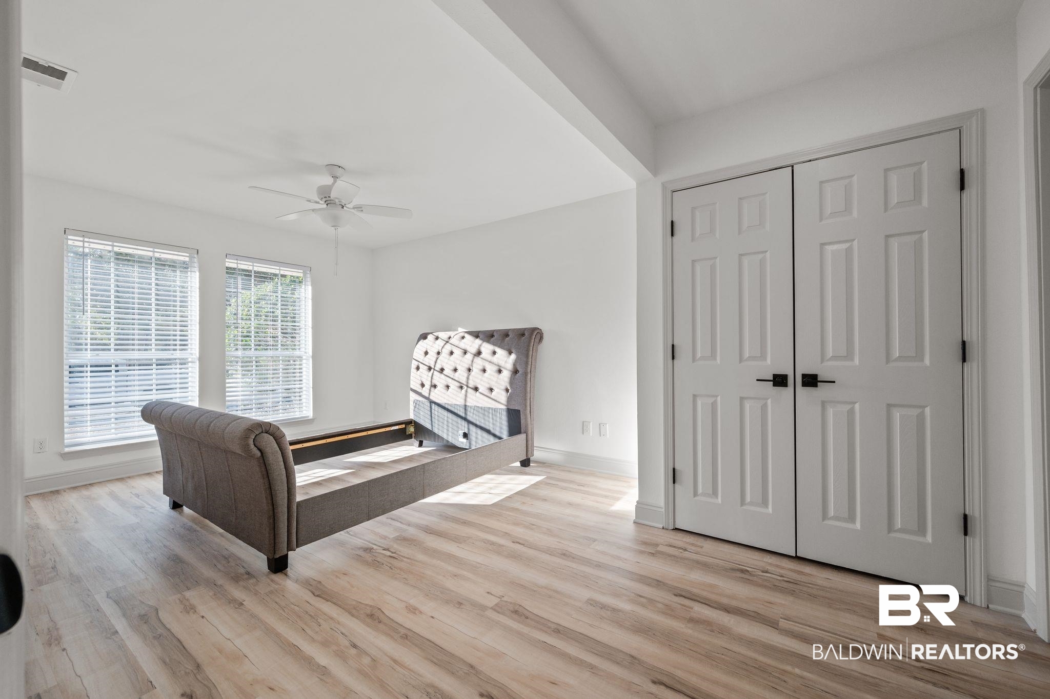 136 Destrehan Road Fairhope, AL 36532 - Photo 18 of 44 Bedroom with light hardwood / wood-style flooring, a closet, and ceiling fan