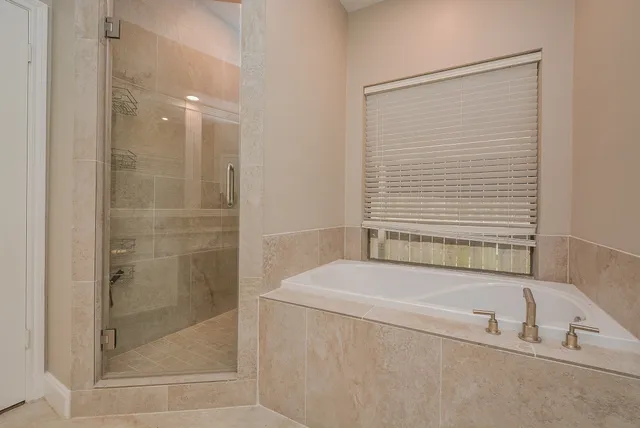a bathroom with a bathtub and shower